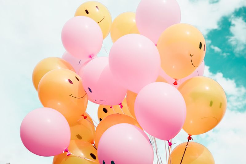 Bunch of balloons some smiling some frowning